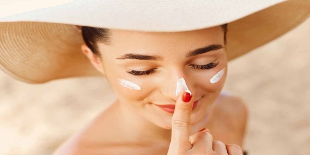 A person applying cream on her face AI-generated content may be incorrect.